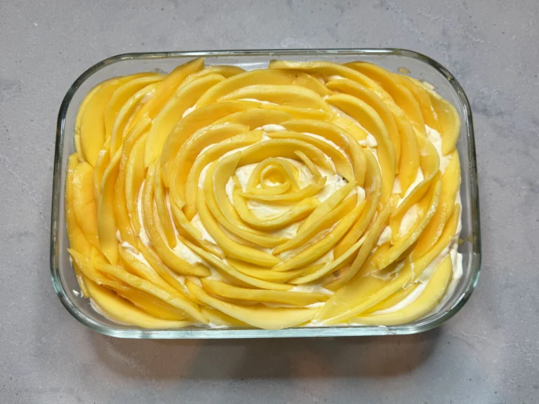Mango float dessert with layers of cream and mango.