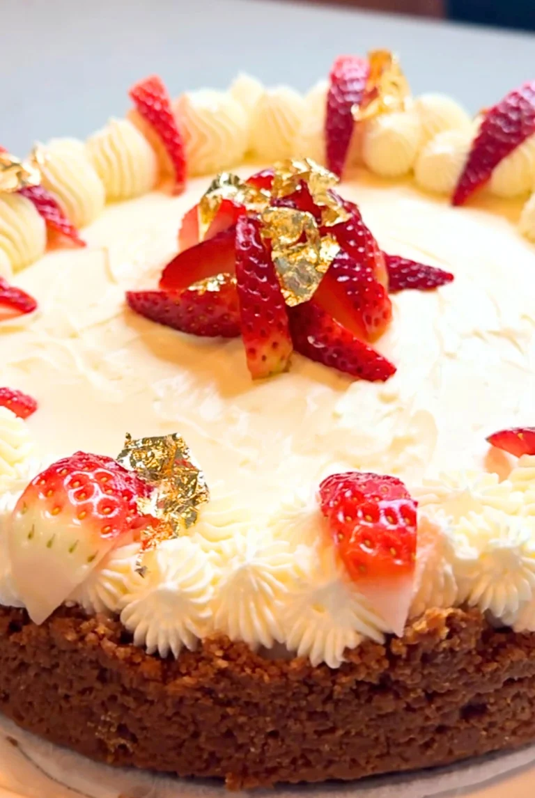 Silky no-bake Biscoff cheesecake with a spiced cookie crust and smooth Biscoff topping, styled on a serving plate