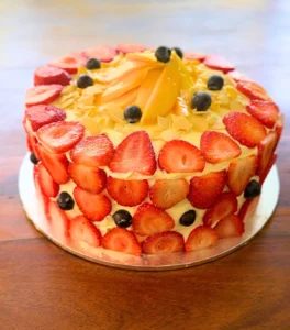 Pandan chiffon cake layered with pandan chantilly cream, topped with festive fresh fruit and a light, airy sponge texture.