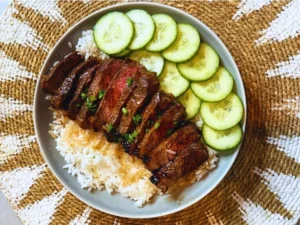 Char Siu-inspired Shimo Wagyu rump steak glazed with a sticky sweet and savoury marinade, served over jasmine rice with fresh cucumber slices.
