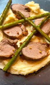 Filipino-inspired sticky pork fillet with mashed potato, asparagus and crispy garlic.
