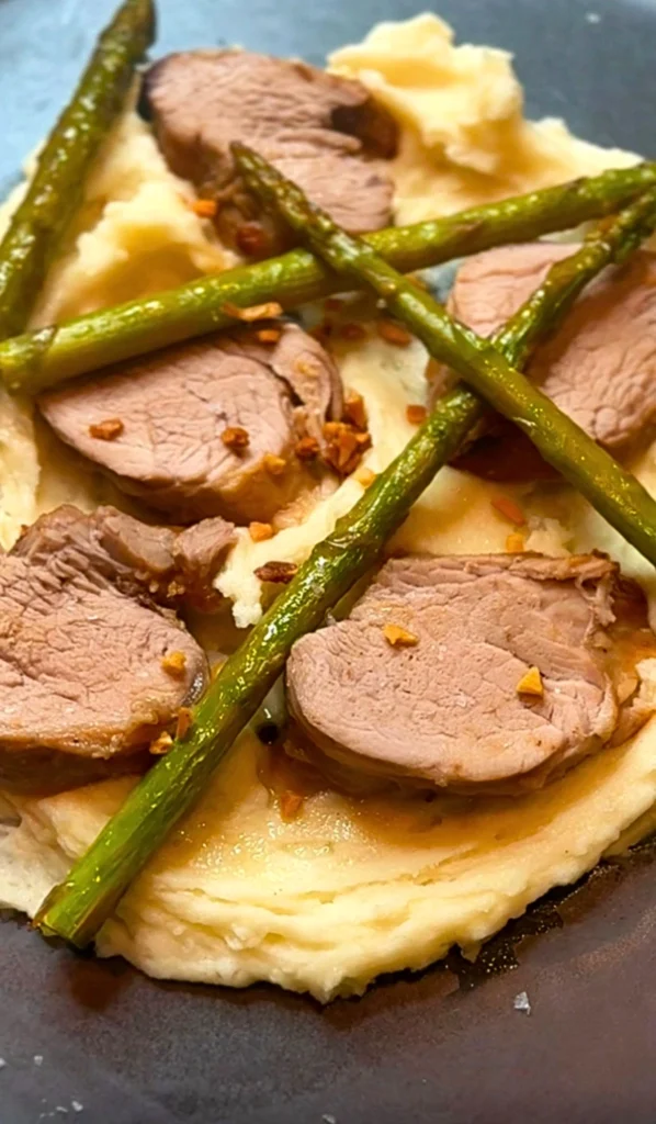 Filipino-inspired sticky pork fillet with mashed potato, asparagus and crispy garlic.
